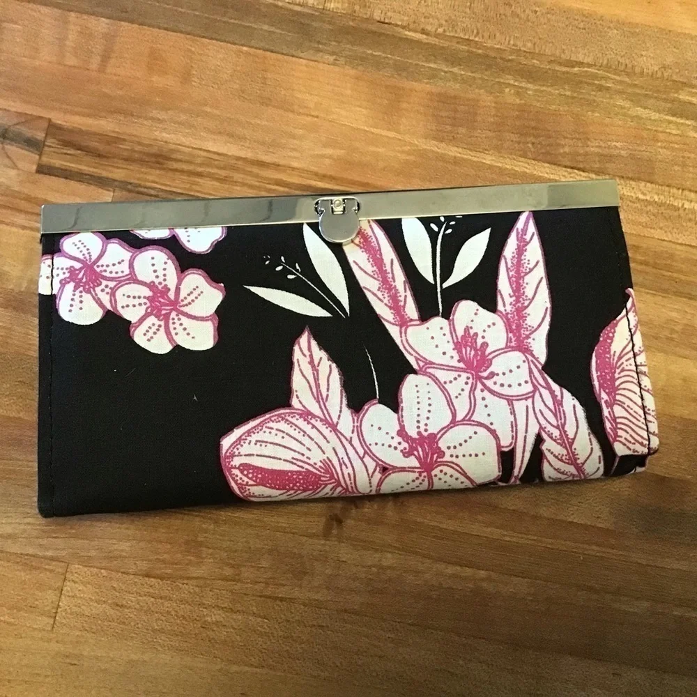 Magid woven grass black clutch and one no brand floral print wallet.